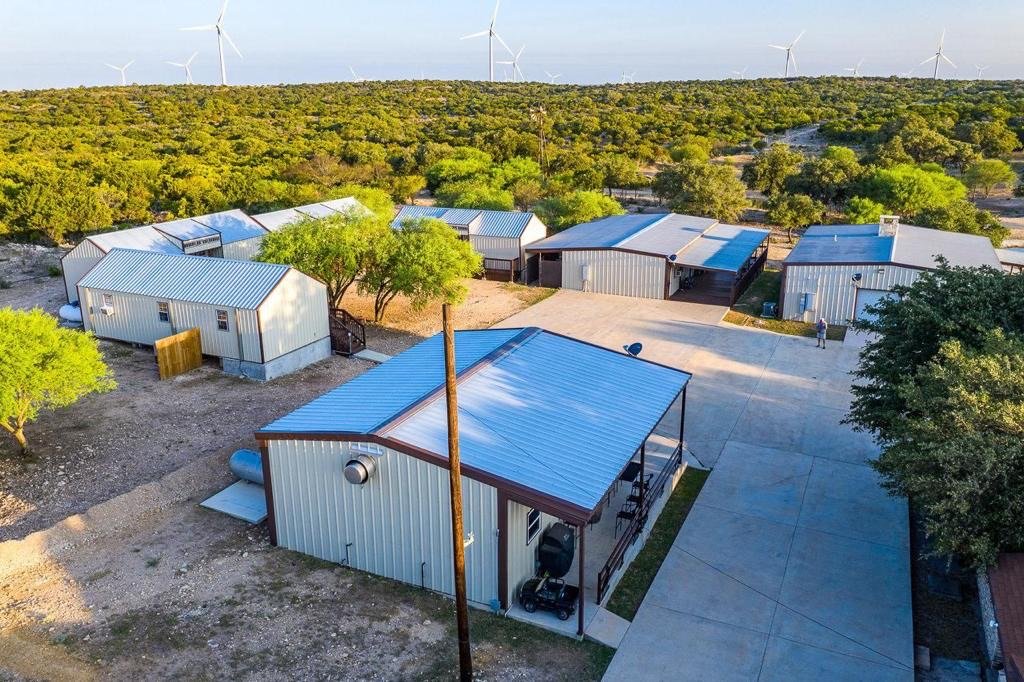 Exterior view of Los Milagros Ranch hunting lodge surrounded by Texas wilderness
