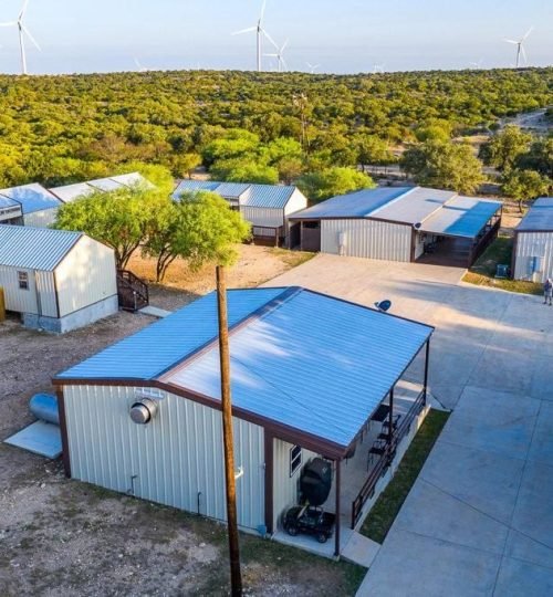 Exterior view of Los Milagros Ranch hunting lodge surrounded by Texas wilderness